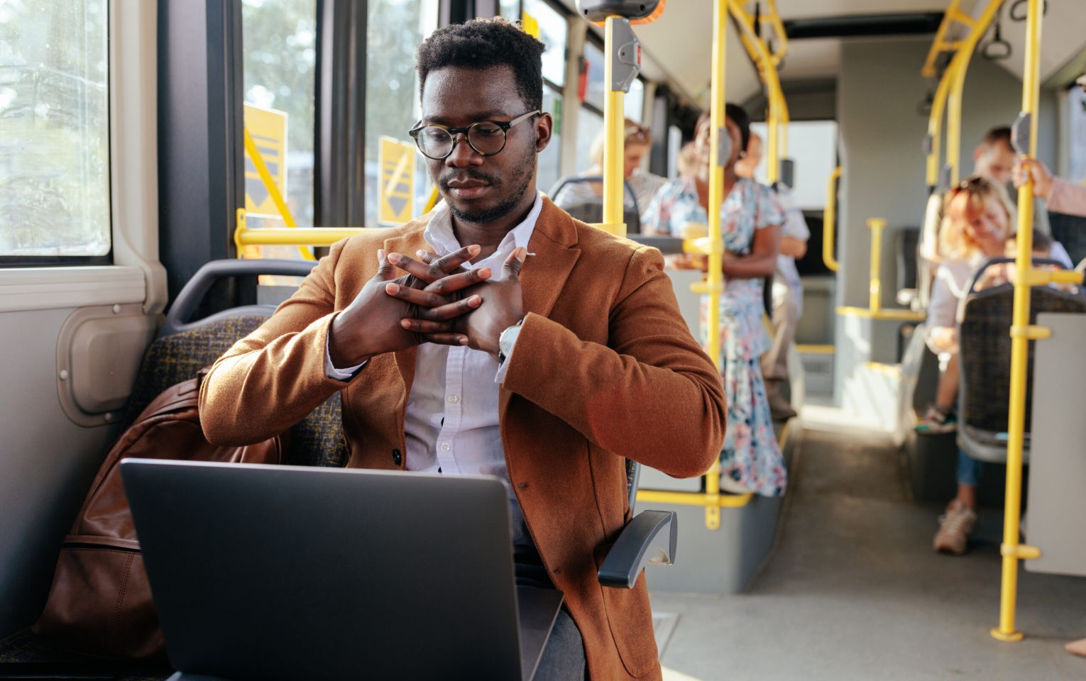 Man on laptop in public transport