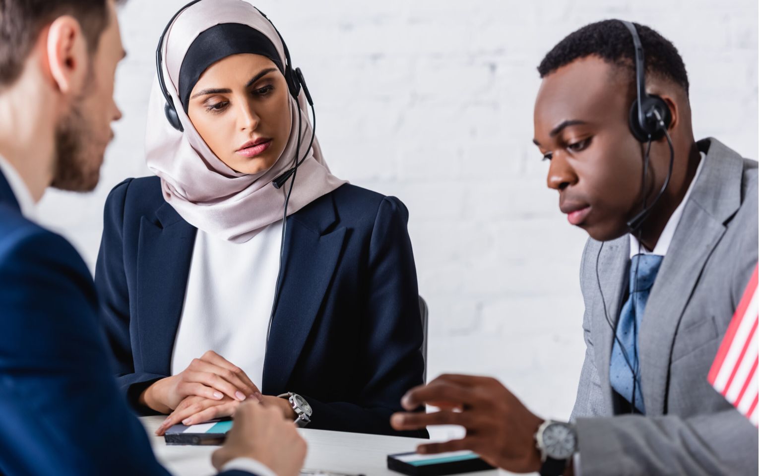 arabian and african american business people in headsets near di